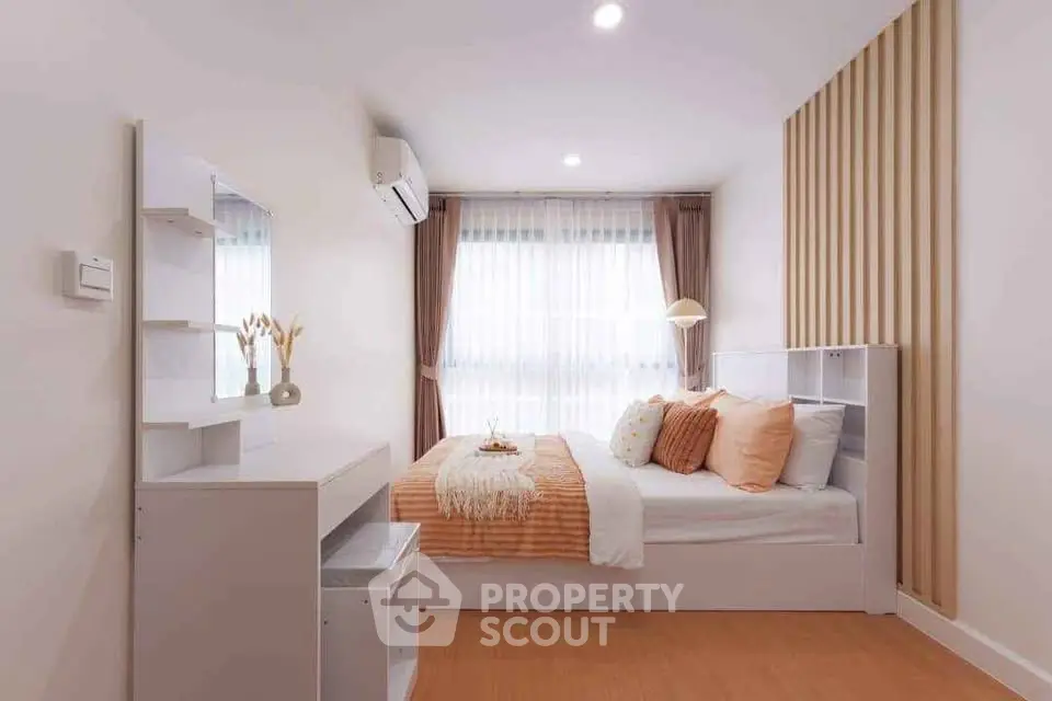 Modern bedroom with stylish decor and natural light, featuring a cozy bed and elegant furnishings.