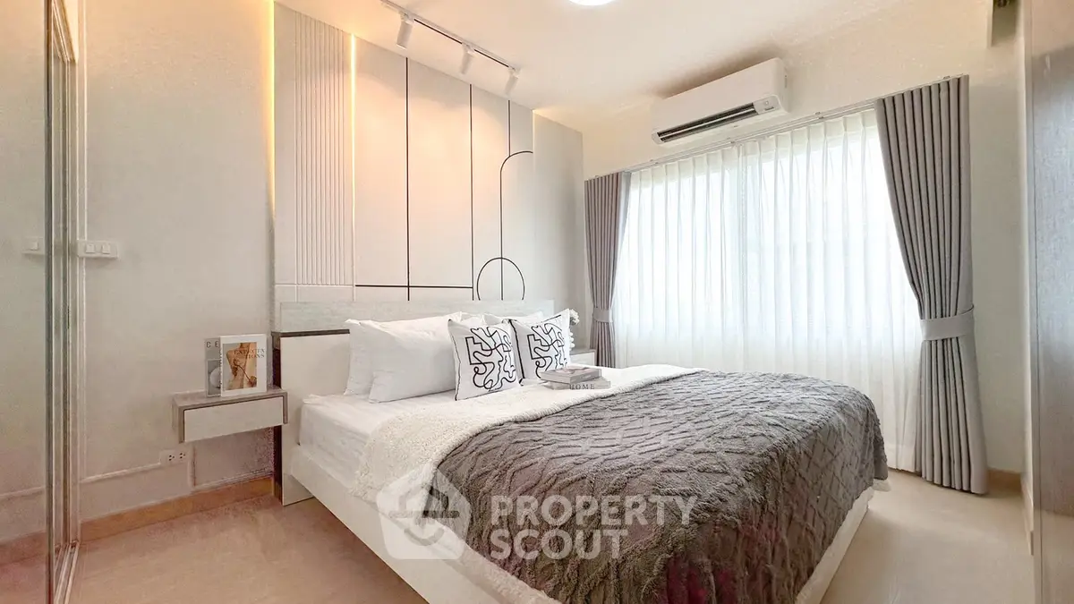 Modern bedroom with stylish decor and natural light