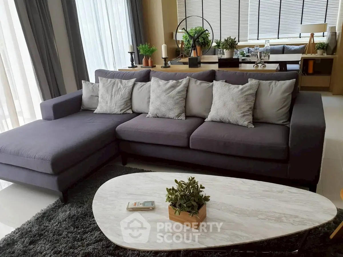 Modern living room with stylish gray sectional sofa and chic decor