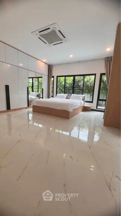 Luxurious bedroom with large windows and modern design