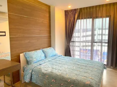 Cozy bedroom with modern decor and large window for natural light