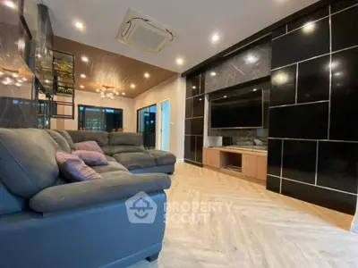 Luxurious modern living room with sleek black accents and spacious seating area