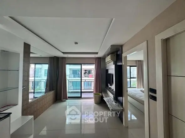 Modern living room with sleek design and large windows offering abundant natural light.