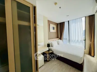 Modern bedroom with large window and stylish decor