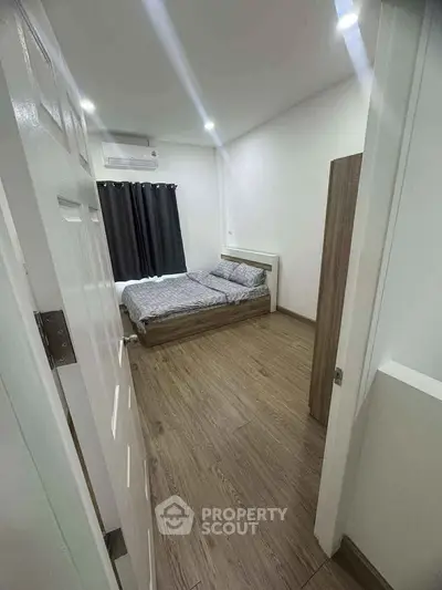 Cozy bedroom with wooden flooring and modern decor