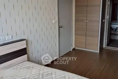 Modern bedroom with wooden flooring and built-in wardrobe, perfect for urban living.