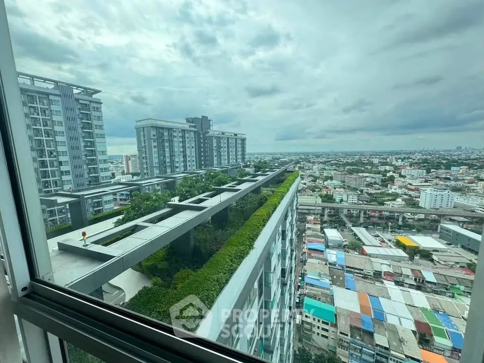 Stunning cityscape view from high-rise apartment window, showcasing modern architecture and urban landscape.