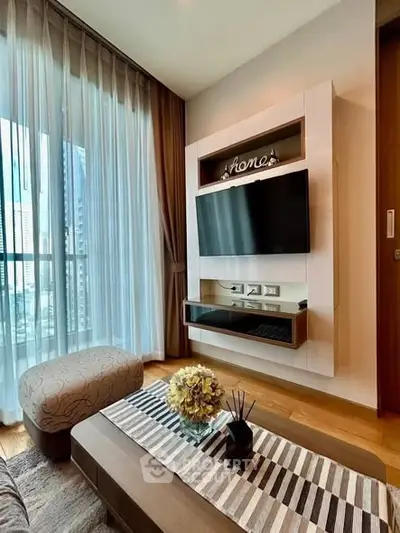 Modern living room with stylish decor and large window view in a high-rise apartment.