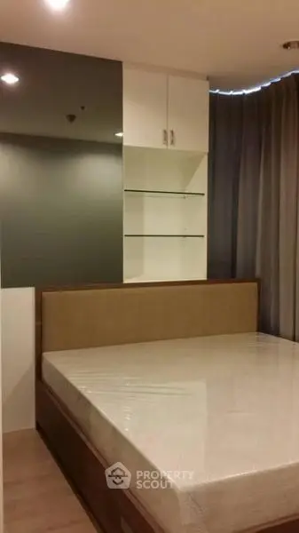 Modern bedroom with built-in shelves and large window curtains