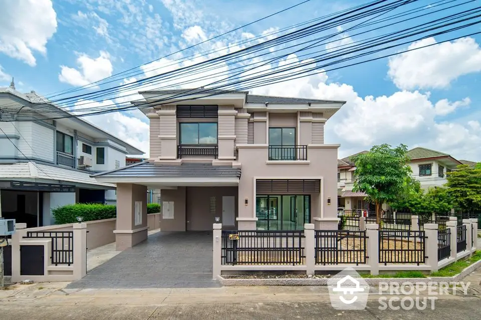 Modern two-story house with spacious driveway and fenced yard in suburban neighborhood.