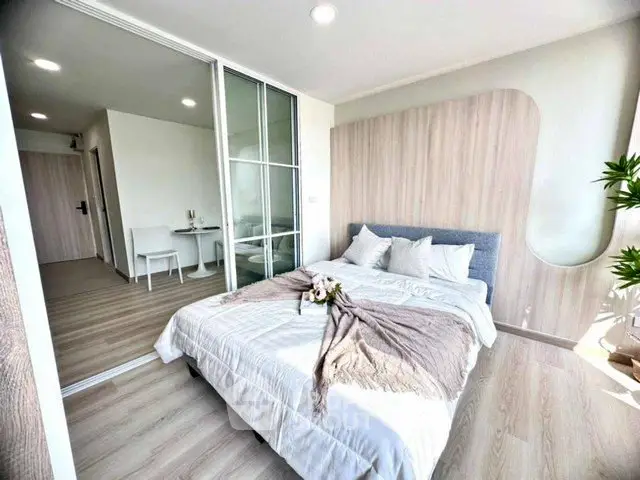 Modern bedroom with stylish decor and natural light in a contemporary apartment.