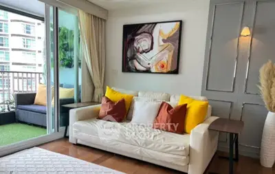 Stylish living room with modern art and balcony view in luxury apartment