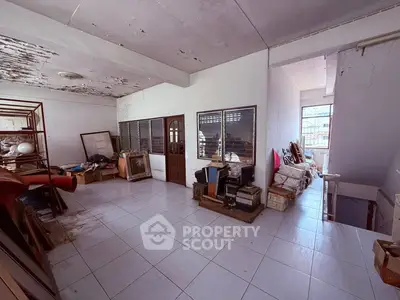 Spacious storage room with ample natural light and potential for renovation.