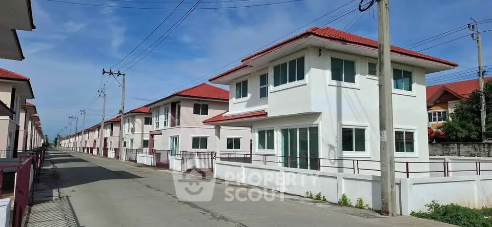 Charming suburban neighborhood with modern two-story homes featuring red roofs and spacious layouts.