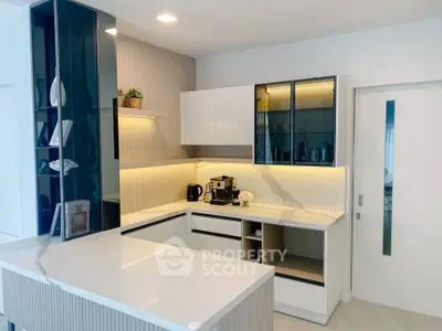 Modern kitchen with sleek white cabinets and marble countertops