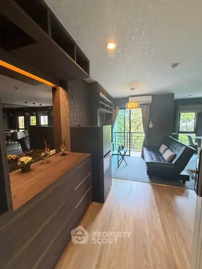 Modern living room with stylish decor and natural light, featuring a sleek sofa and elegant lighting.