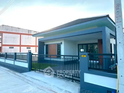 Modern single-story house with sleek design and spacious driveway