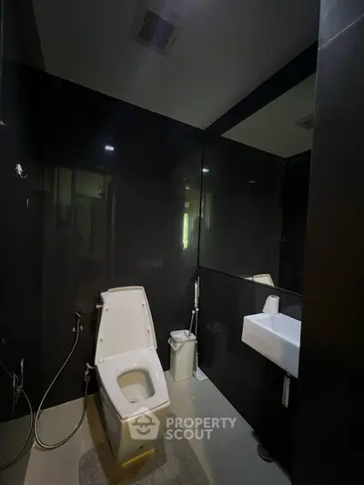 Modern bathroom with sleek black tiles and contemporary fixtures