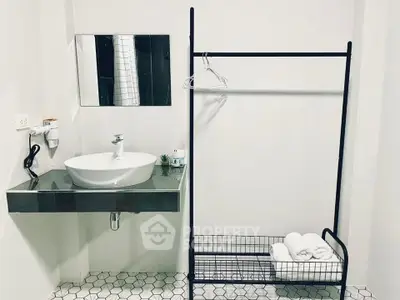 Modern minimalist bathroom with sleek sink and towel rack