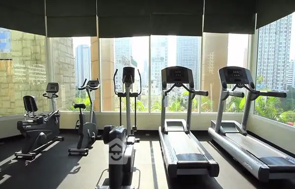 Modern gym with city view and state-of-the-art fitness equipment.