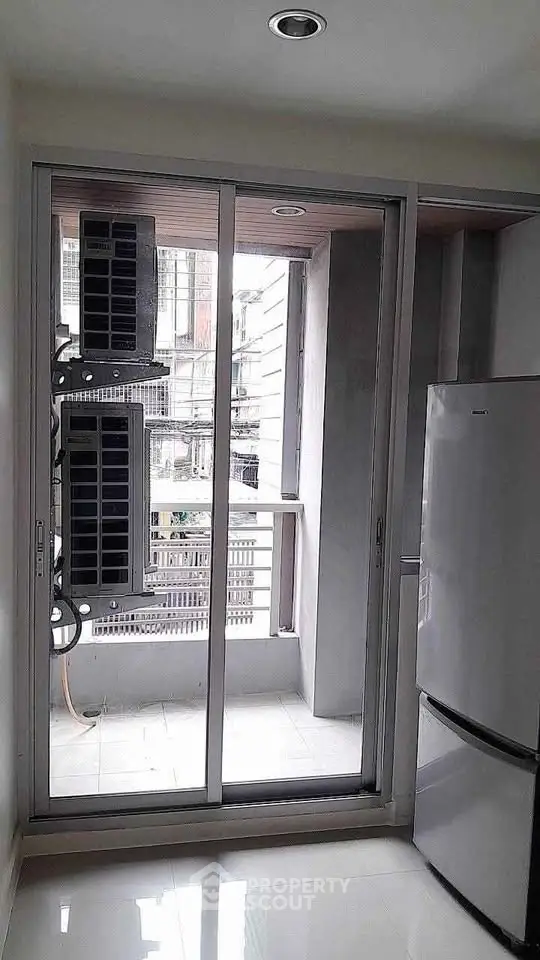 Modern apartment with balcony and sleek appliances, perfect for urban living.