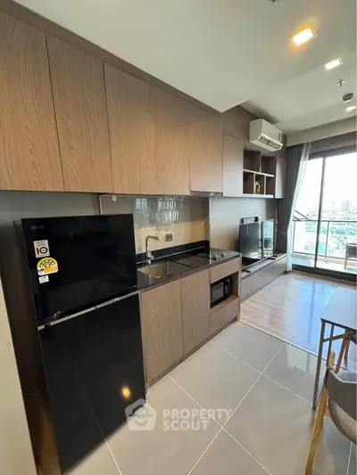 Modern kitchen with sleek cabinetry and open layout in a stylish apartment with city view.