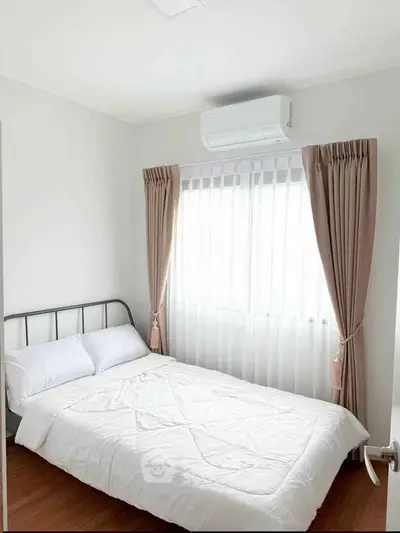 Cozy bedroom with natural light and modern air conditioning unit