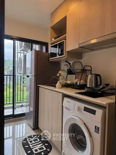 Modern kitchen with washing machine and balcony view in stylish apartment
