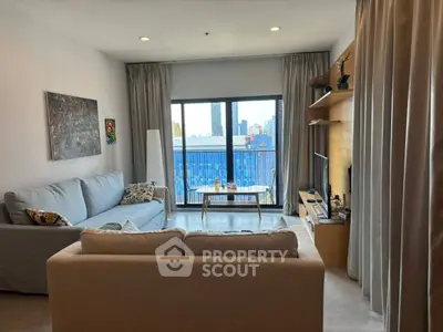 Modern living room with city view, cozy sofas, and stylish decor in urban apartment.