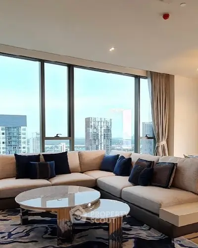 Luxurious living room with panoramic city view and elegant furnishings.