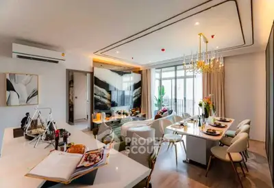 Luxurious open-plan living and dining area with modern decor and elegant lighting.