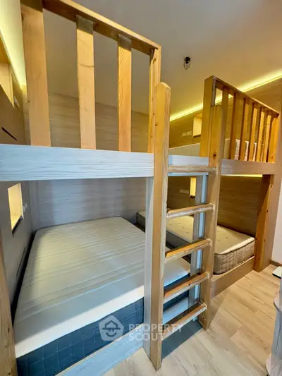 Modern bunk bed setup in cozy wooden-themed bedroom with natural lighting