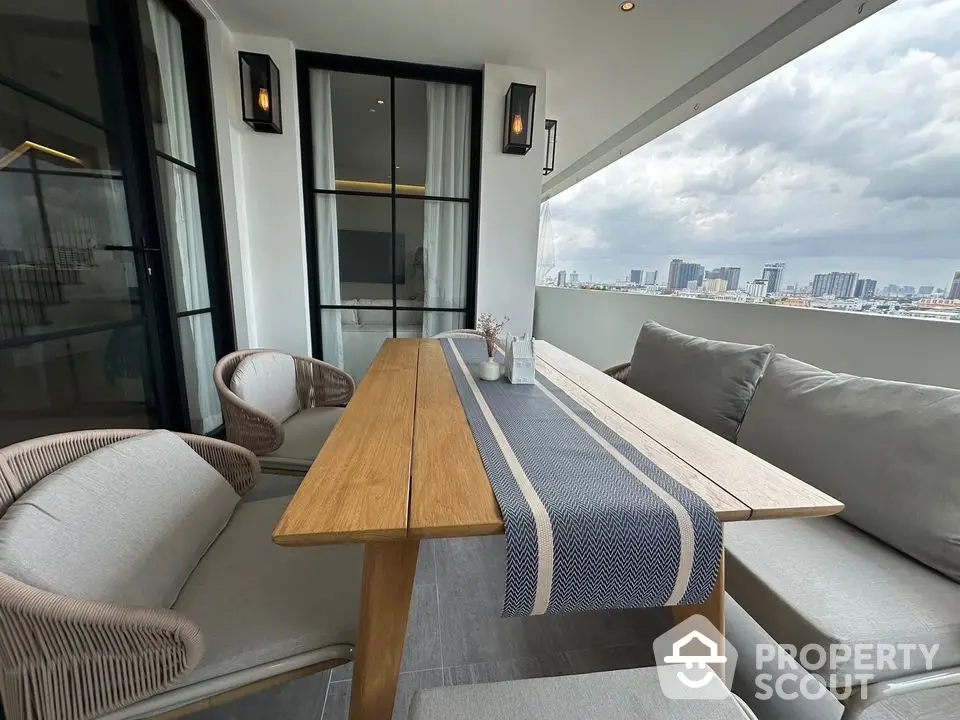 Stylish balcony with modern furniture and city view, perfect for relaxation and entertaining.