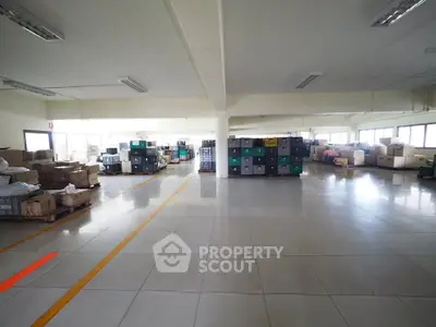 Spacious warehouse interior with organized storage and ample natural light.