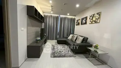 Modern living room with sleek black furniture and elegant decor