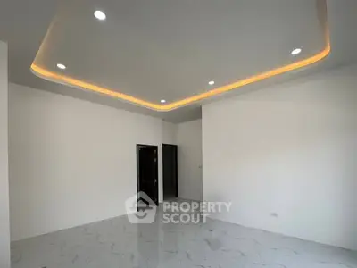 Spacious modern living room with elegant recessed lighting and marble flooring.