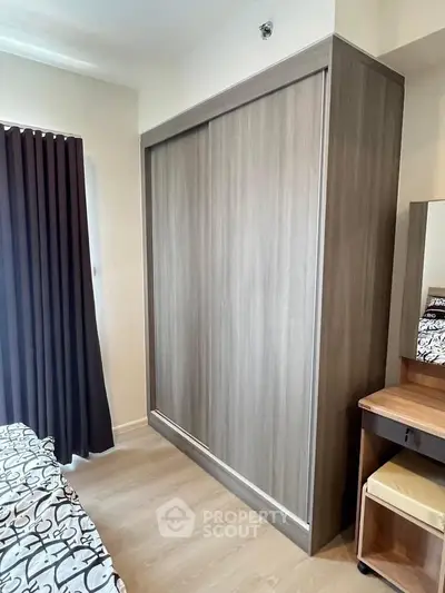 Modern bedroom with sleek wooden wardrobe and stylish decor
