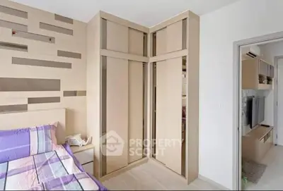 Modern bedroom with stylish wooden wardrobe and cozy bed with colorful bedding.