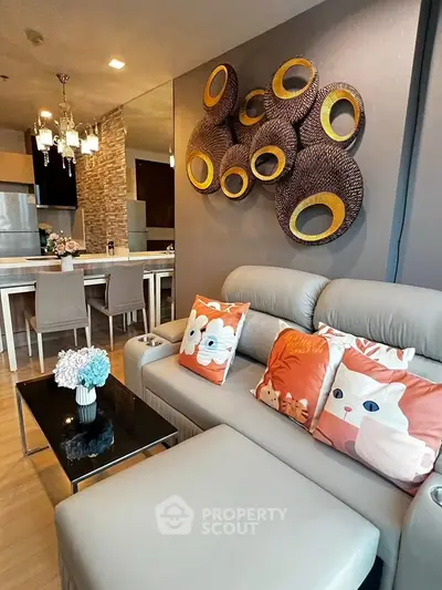 Stylish living room with modern decor and open kitchen layout in a cozy apartment.