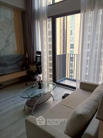 Modern living room with floor-to-ceiling windows and small balcony in urban apartment
