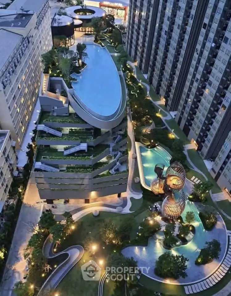 Luxurious high-rise building with stunning rooftop pool and landscaped gardens at dusk.