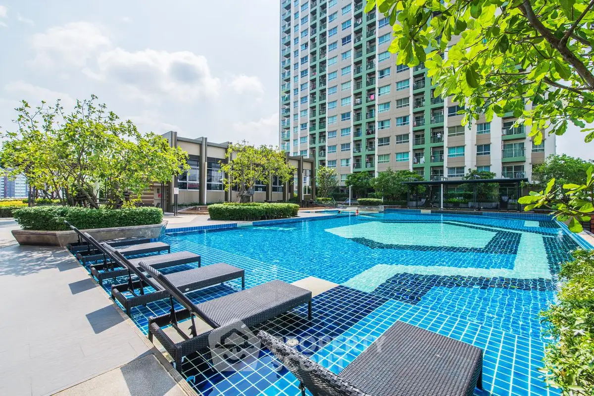 Luxurious apartment complex with stunning outdoor pool and lush greenery