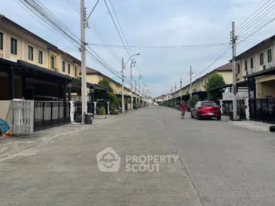 Charming suburban street with modern townhouses and spacious driveways, perfect for family living.