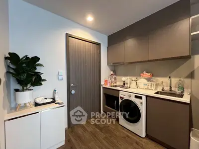 Modern kitchen with sleek cabinetry and built-in appliances in a stylish apartment.