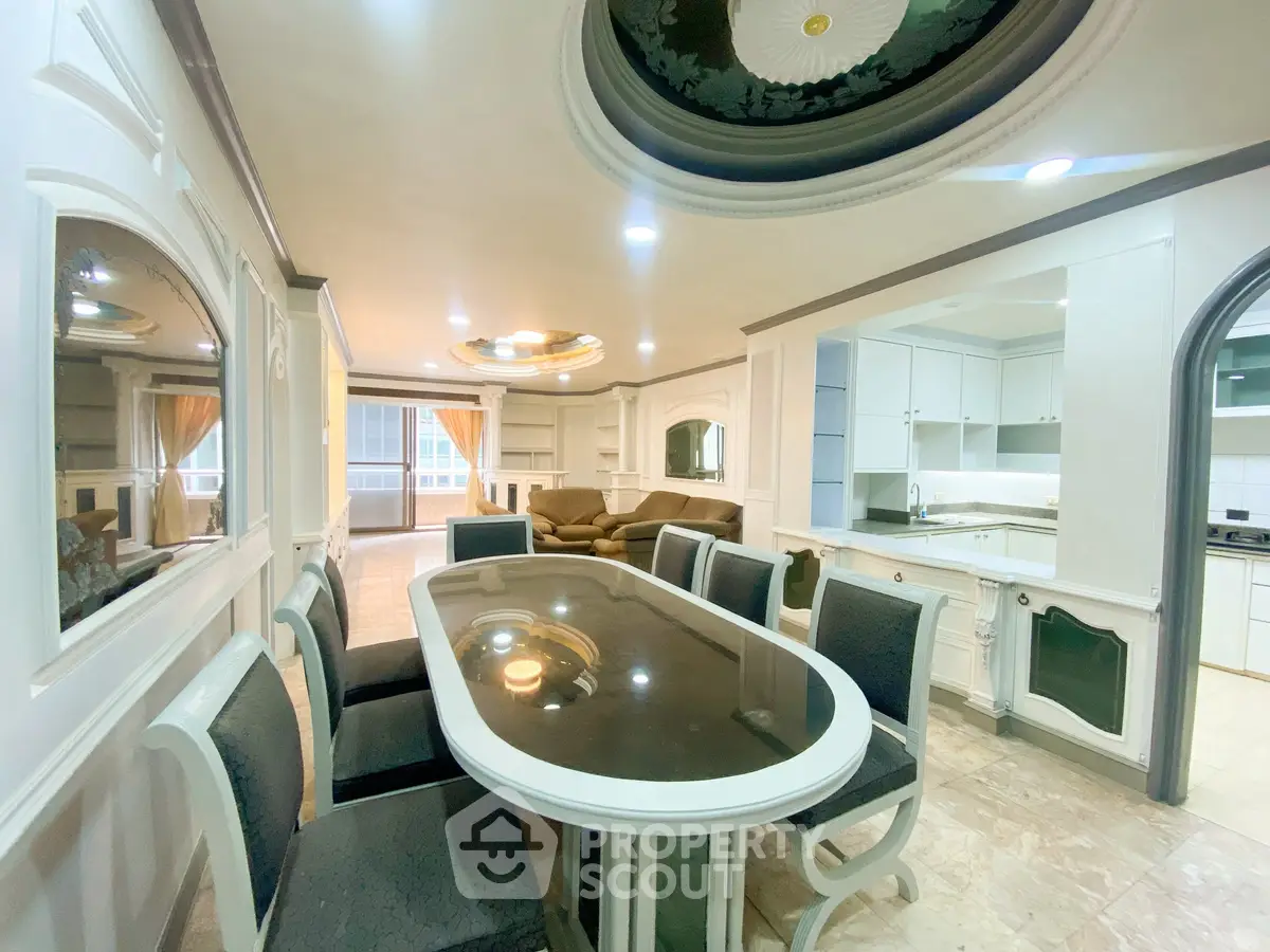 Luxurious dining and living area with elegant decor and modern kitchen