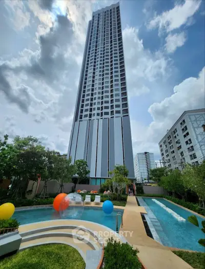 Stunning high-rise building with a luxurious pool and lush garden, perfect for urban living.