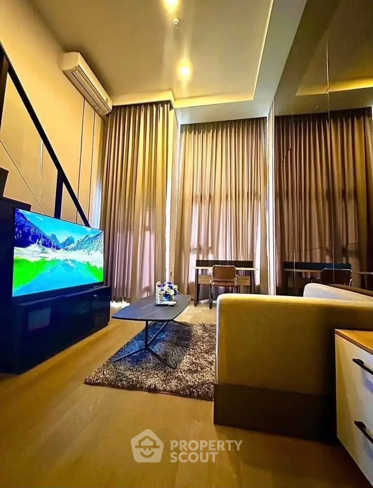 Luxurious living room with high ceilings, modern decor, and large windows for natural light.