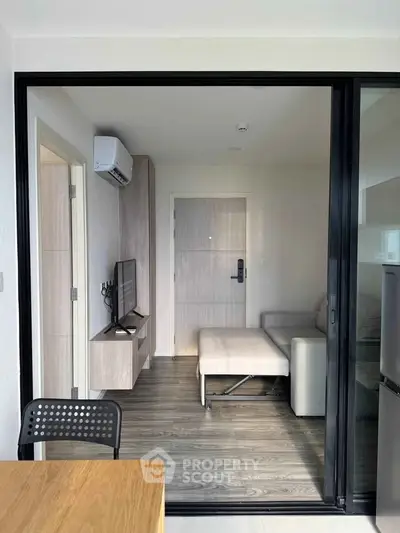 Modern living room with sleek furniture and air conditioning in a stylish apartment.