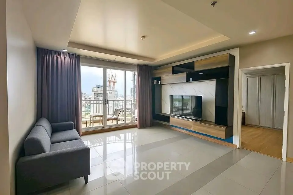 Spacious modern living room with balcony and city view