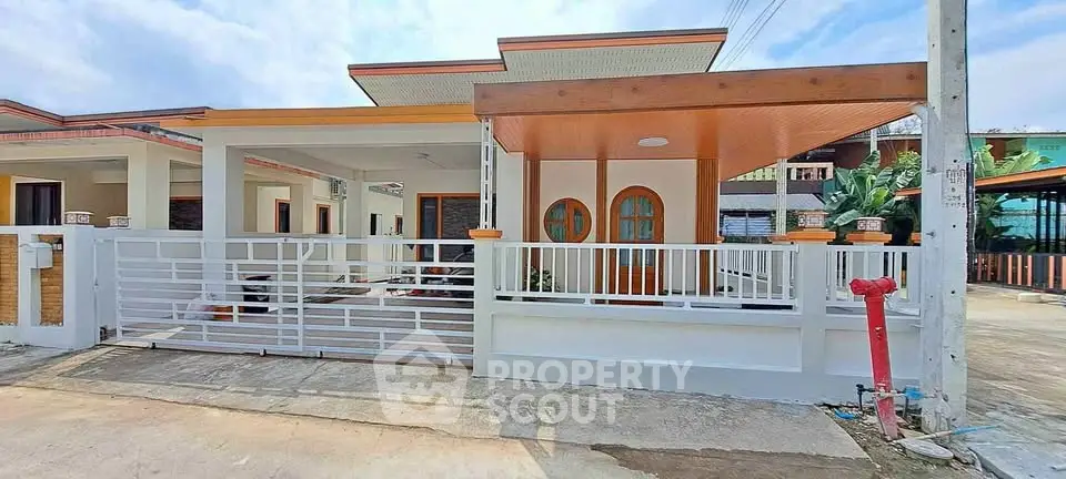 Charming single-story house with modern design and spacious driveway in a serene neighborhood.